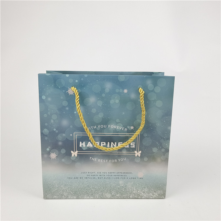 Más vendido Reciclables Logotipo respetuoso con el medio ambiente Bolsa de papel de compras impresa Embalaje Blanco 110 gramos Reutilizable